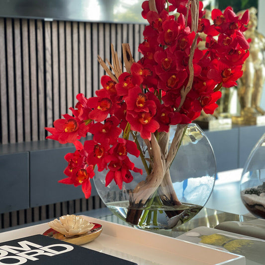 Rote Cymbidium-Orchideen im Moon-Pflanzgefäß